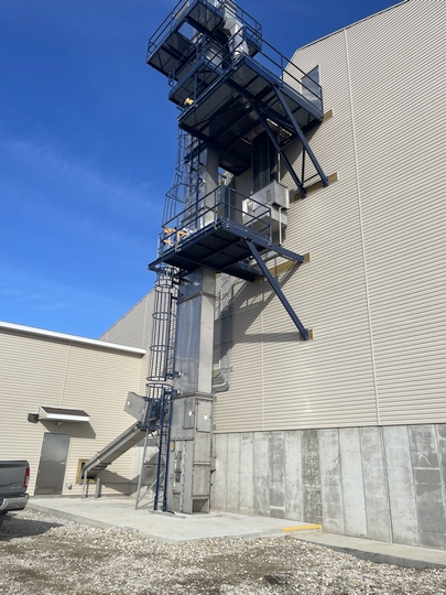 Dry fertilizer bucket elevator is attached to the outside of the building and feeds into a storage shed