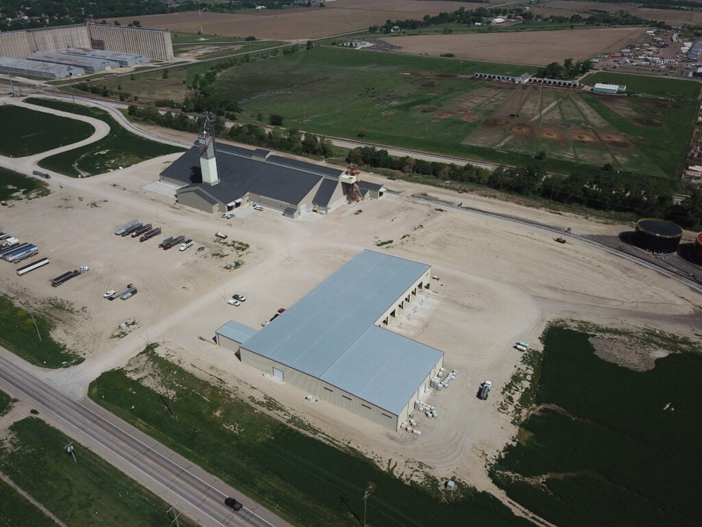 Large Dry Fertilizer blending and storage facility and Liquid fertilizer building from Stueve Construction along a rail siding in nebraska