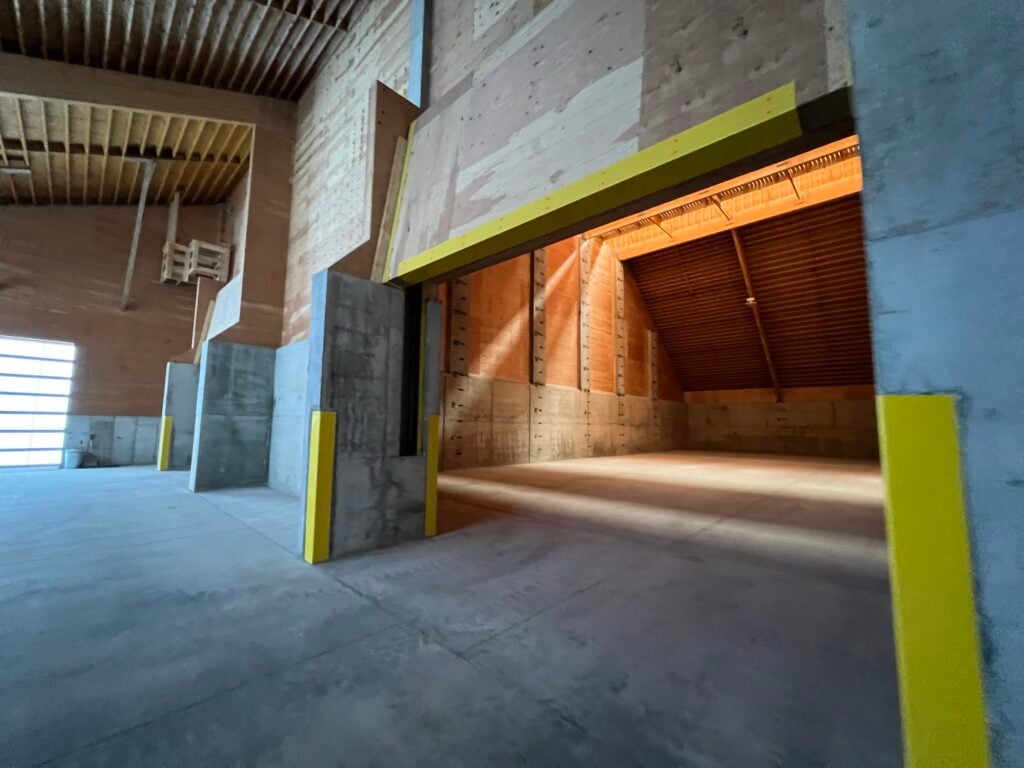 Empty Fertilizer storage bin can hold tons for crop nutrients with yellow imbedded corners