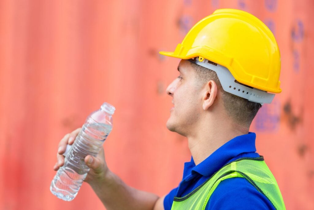 construction worker drinking water on building job site
