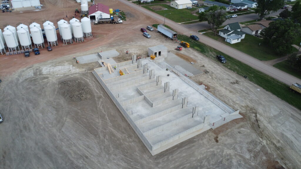 farmer coop dry fertilizer building under construction with product 9 bins