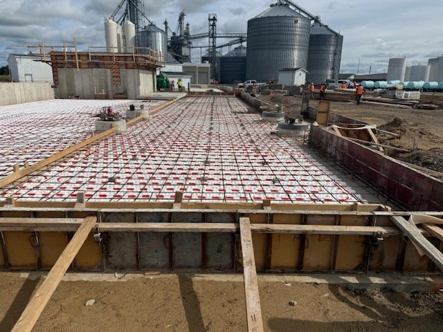 installing a heated tube floor system in a dry fertilizer storage building