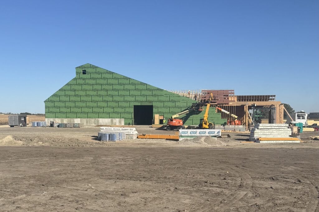 New dry fertilizer storage building under construction in Nebraska with green zip board sheathing