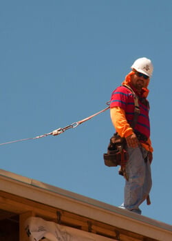 construction worker safety means tied off while at work