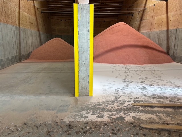Fertilizer dust control inside of a storage bin