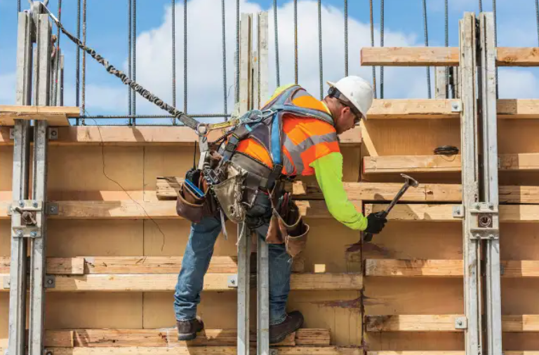 Man working on fertilizer storage building